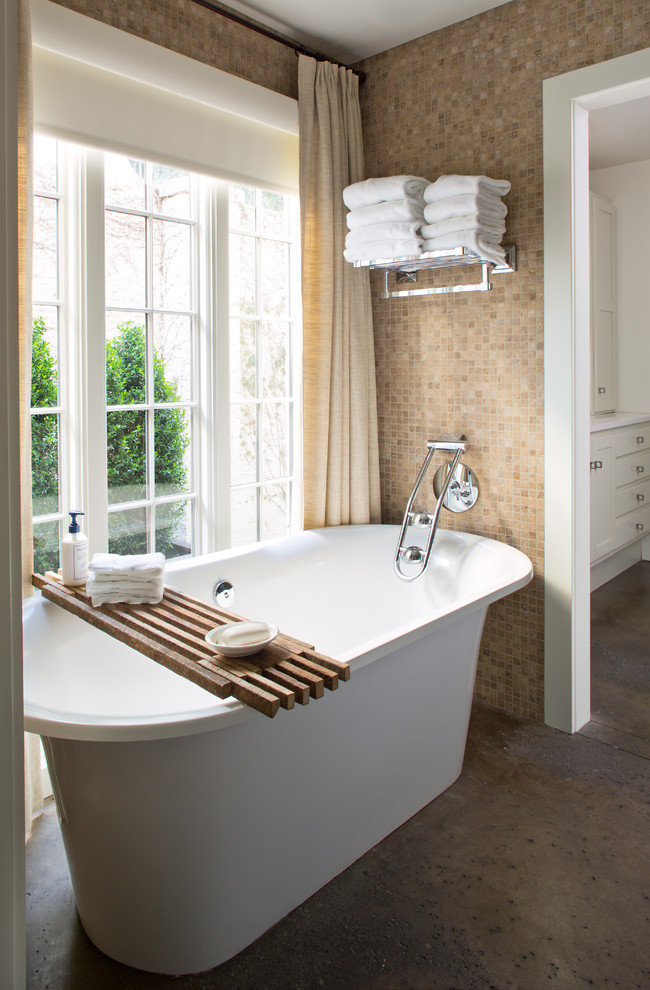 Transitional master bathroom in Denver with a freestanding tub and beige walls.