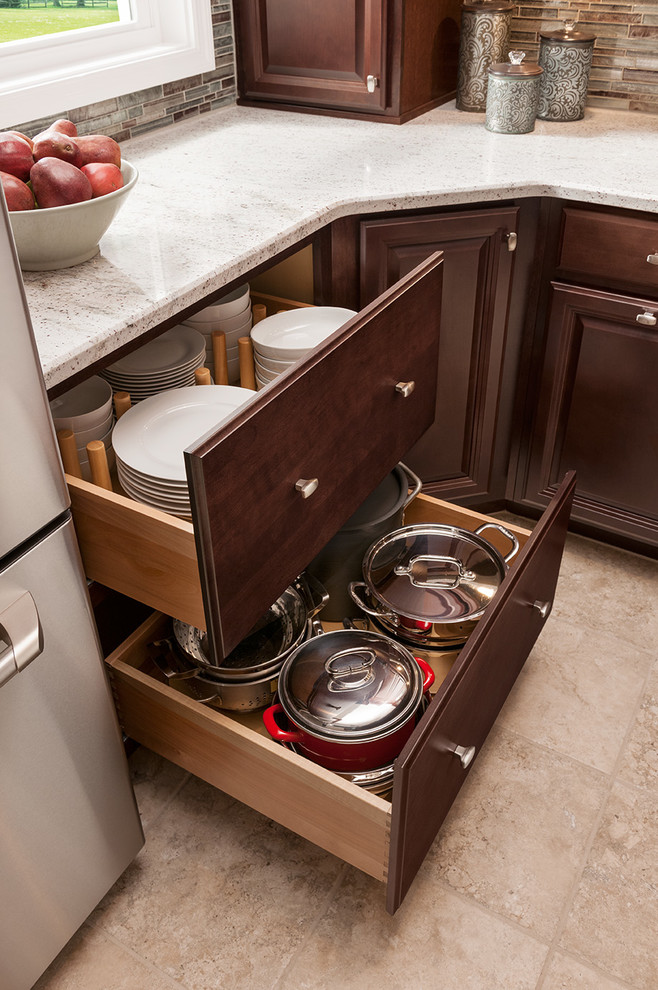 Inspiration for a limestone floor kitchen remodel in DC Metro with raised-panel cabinets, dark wood cabinets, quartz countertops and stainless steel appliances