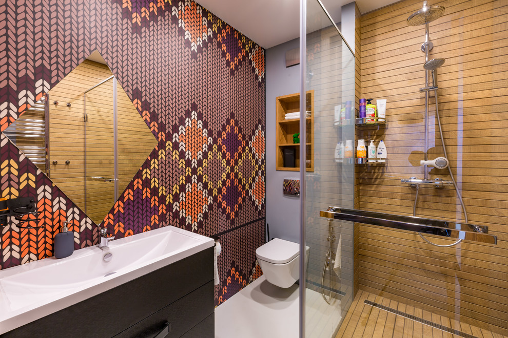 Photo of a contemporary bathroom in Other with flat-panel cabinets, black cabinets, a corner shower, a wall-mount toilet, multi-coloured tile, purple walls, white floor, a hinged shower door and an integrated sink.
