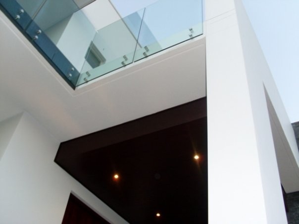 This is an example of a large contemporary two-storey stucco white exterior in Sydney with a flat roof.