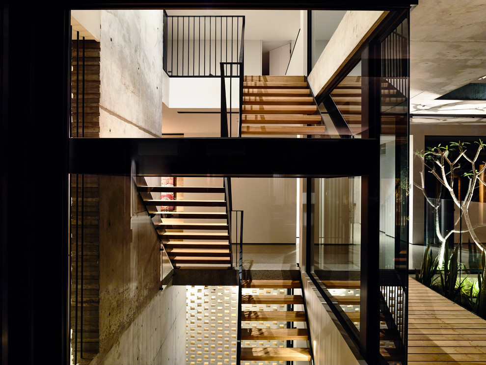 Photo of a large modern wood floating staircase in Melbourne with open risers.