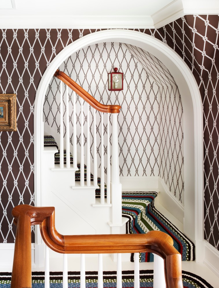 Beach style painted wood staircase in New York with painted wood risers.