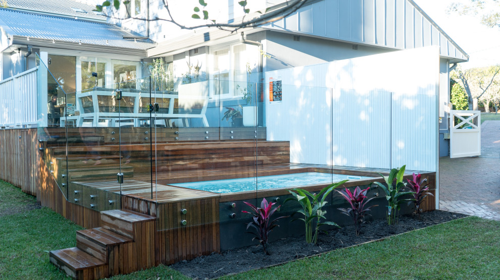 Inspiration för små moderna rektangulär pooler på baksidan av huset, med trädäck