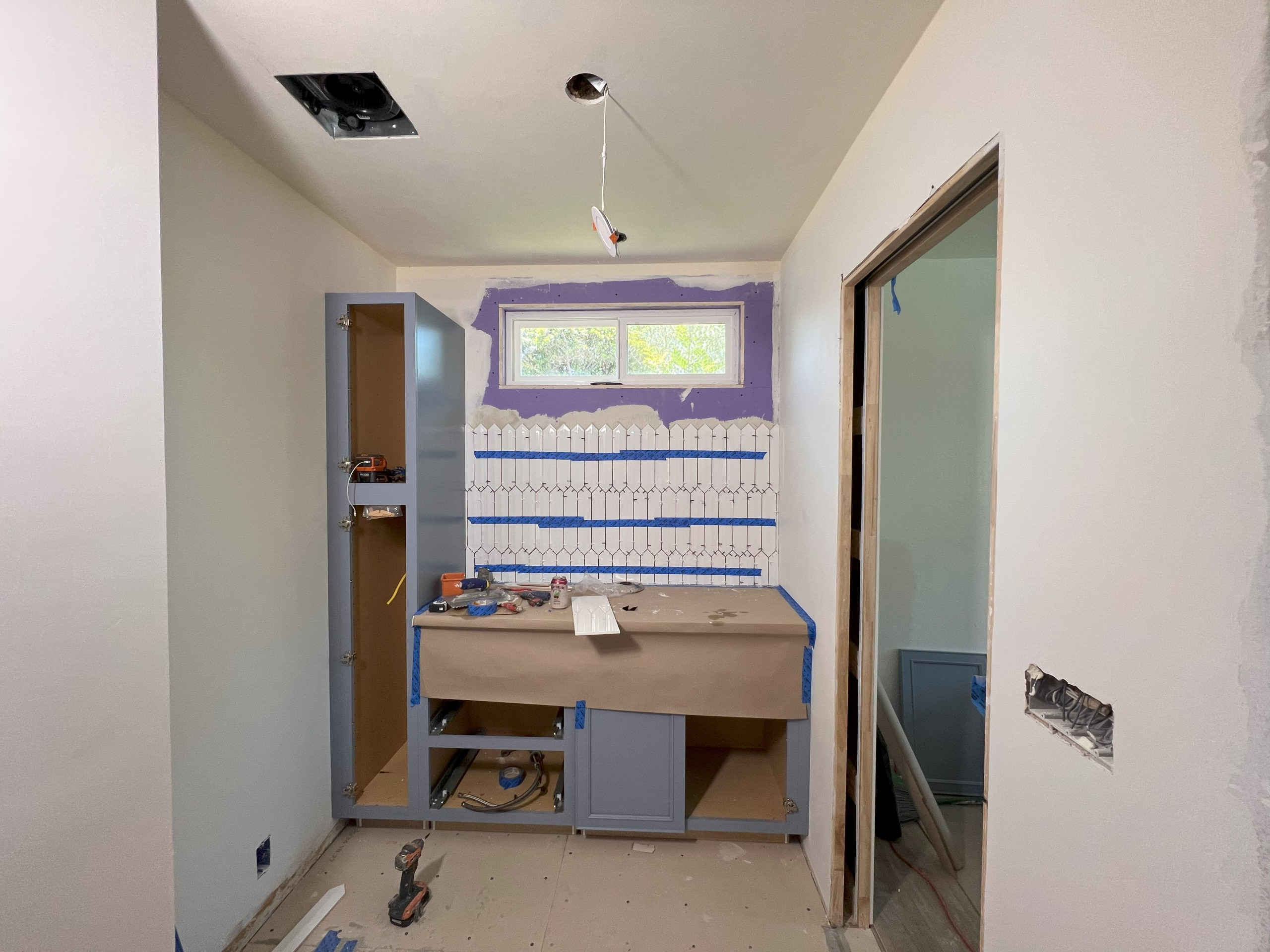 DURING! Vanity Cabinets & Full-height Splash Installation