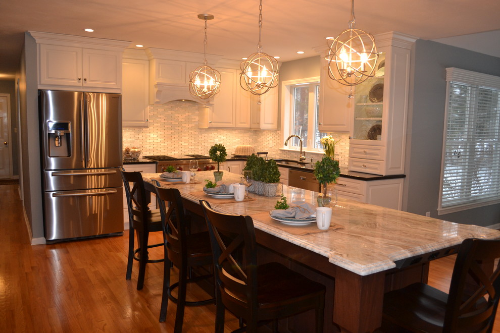 Eat-in kitchen - large transitional u-shaped medium tone wood floor eat-in kitchen idea in Boston with an undermount sink, raised-panel cabinets, white cabinets, granite countertops, white backsplash, ceramic backsplash, stainless steel appliances and white walls