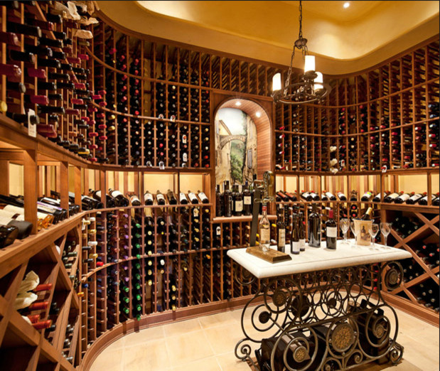 This is an example of a mid-sized traditional wine cellar in Santa Barbara with limestone floors and display racks.