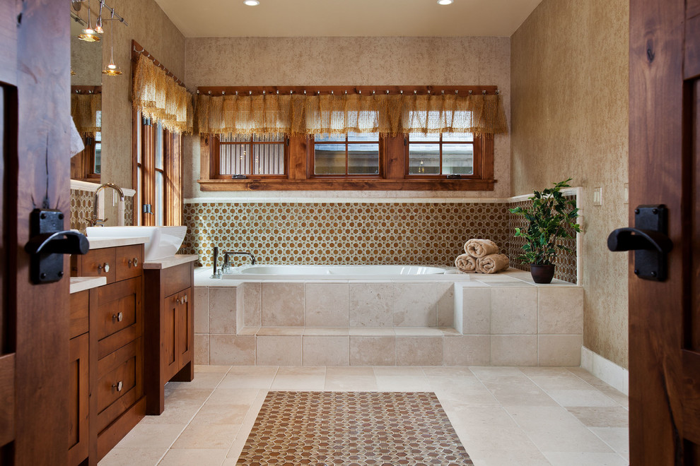 This is an example of a traditional bathroom in Denver with stone tile.