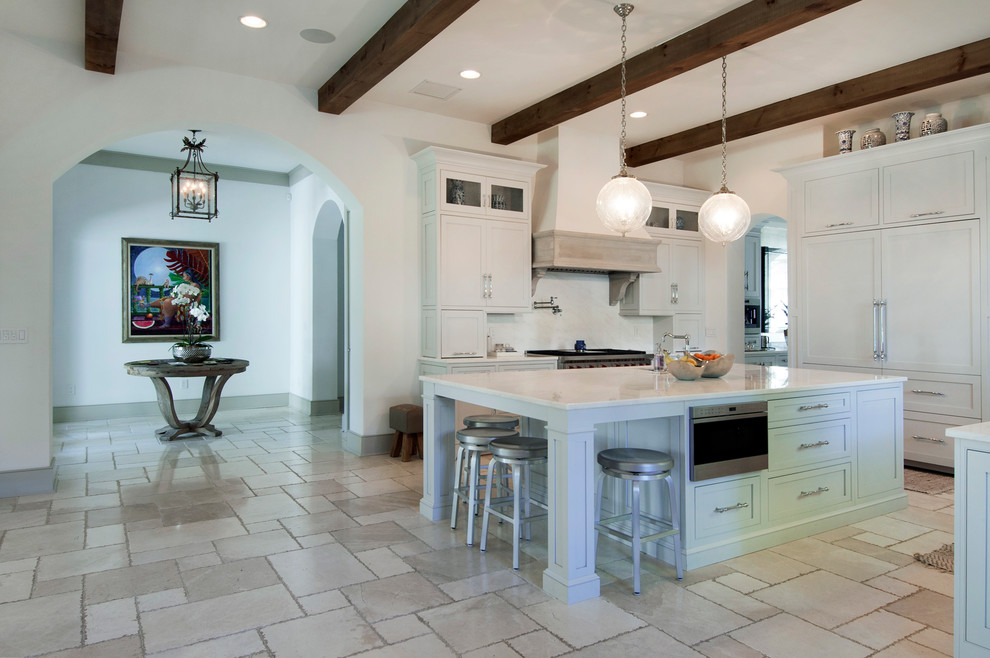 This is an example of a mid-sized mediterranean eat-in kitchen in Tampa with coloured appliances and with island.