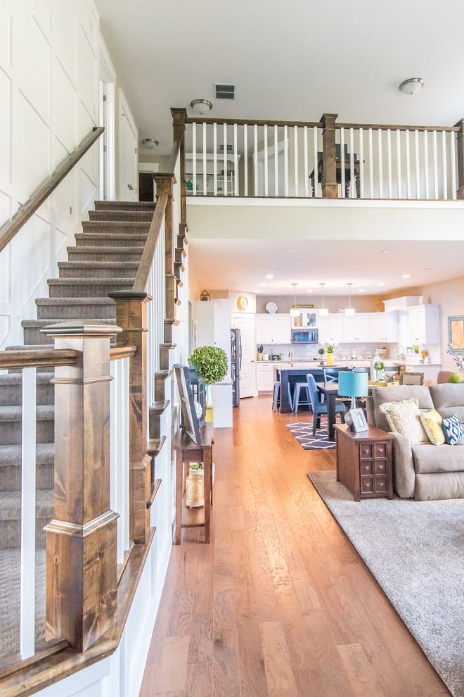 This is an example of a mid-sized arts and crafts carpeted l-shaped staircase in Salt Lake City with painted wood risers.