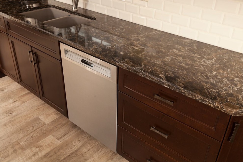 Kitchen - transitional kitchen idea in Toronto with shaker cabinets, dark wood cabinets, granite countertops, white backsplash, subway tile backsplash and stainless steel appliances