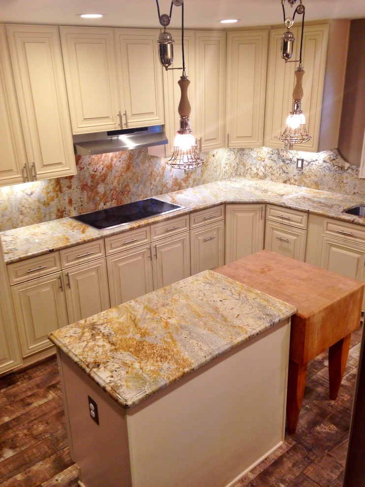Photo of a large country u-shaped separate kitchen in DC Metro with an undermount sink, raised-panel cabinets, white cabinets, granite benchtops, multi-coloured splashback, stone slab splashback, stainless steel appliances, ceramic floors and with island.