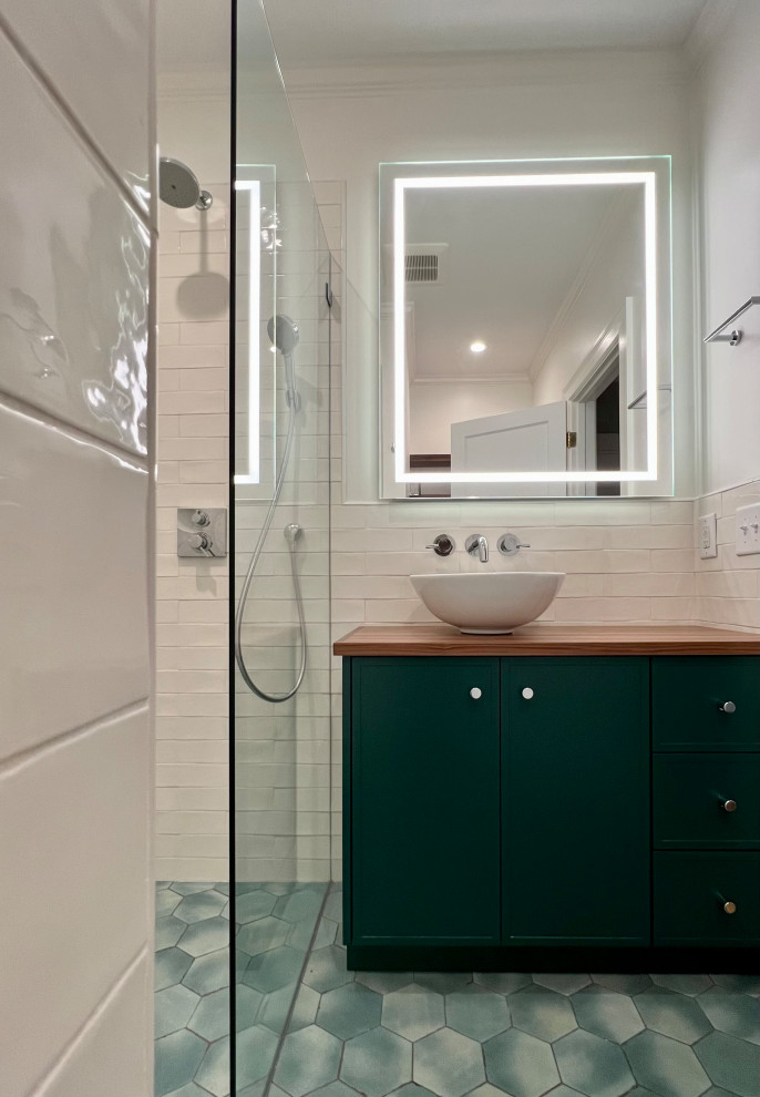 Bathroom - transitional bathroom idea with green cabinets