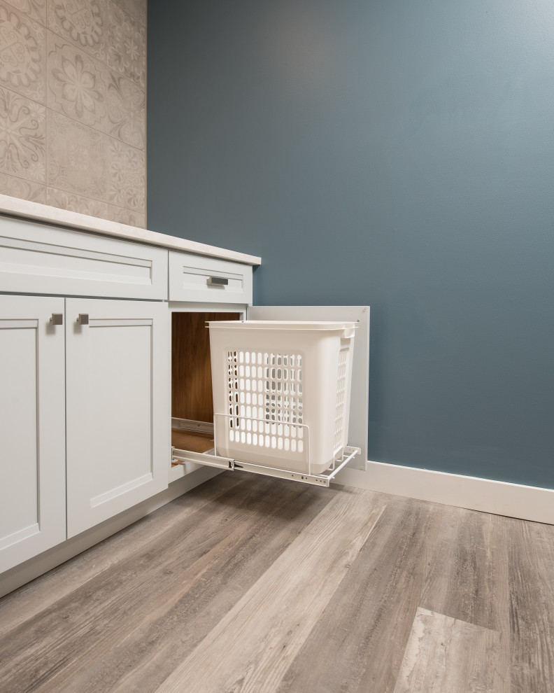 This is an example of a mid-sized transitional galley dedicated laundry room in Other with an undermount sink, recessed-panel cabinets, white cabinets, quartz benchtops, beige walls, laminate floors, a side-by-side washer and dryer, beige floor and white benchtop.