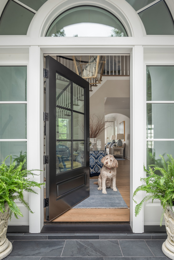 Inspiration for a coastal ceramic tile and gray floor entryway remodel in Tampa with a black front door