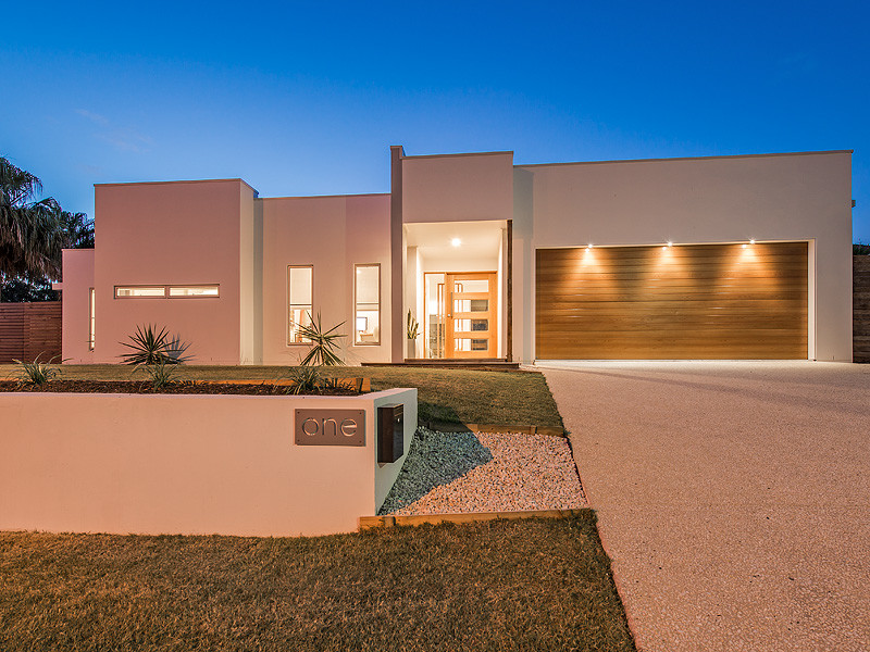 This is an example of a mid-sized contemporary one-storey white exterior in Sunshine Coast.