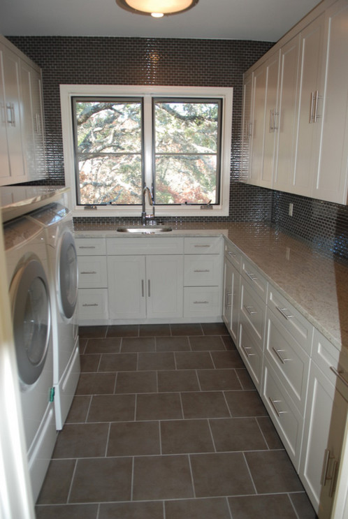 Photo of a mid-sized country u-shaped dedicated laundry room in Austin with an undermount sink, recessed-panel cabinets, white cabinets, granite benchtops and a side-by-side washer and dryer.