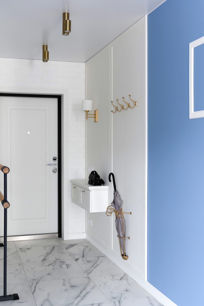 Inspiration for a mid-sized transitional front door in Other with white walls, porcelain floors, a single front door, a white front door, grey floor and brick walls.