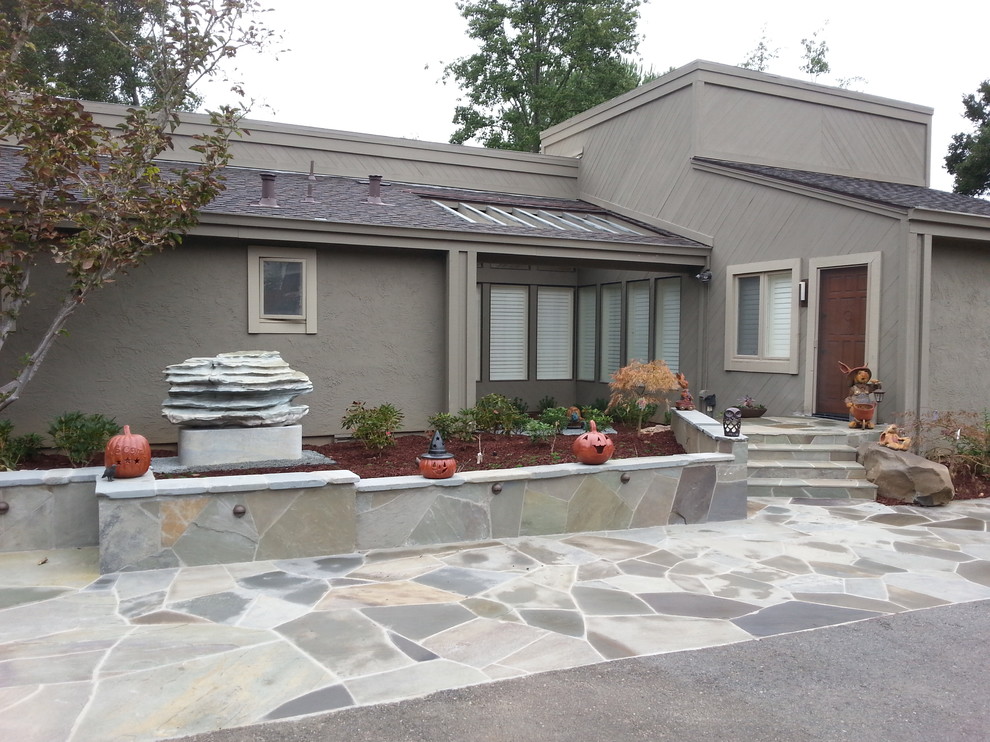 Photo of a mid-sized asian front yard full sun garden in San Francisco with a retaining wall and natural stone pavers.