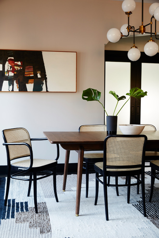 Photo of a beach style dining room in Los Angeles with no fireplace and grey walls.