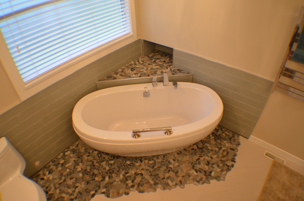 Photo of a small transitional master bathroom in Vancouver with shaker cabinets, white cabinets, a freestanding tub, a corner shower, a one-piece toilet, beige tile, brown tile, gray tile, white tile, pebble tile, beige walls, porcelain floors, an undermount sink and engineered quartz benchtops.