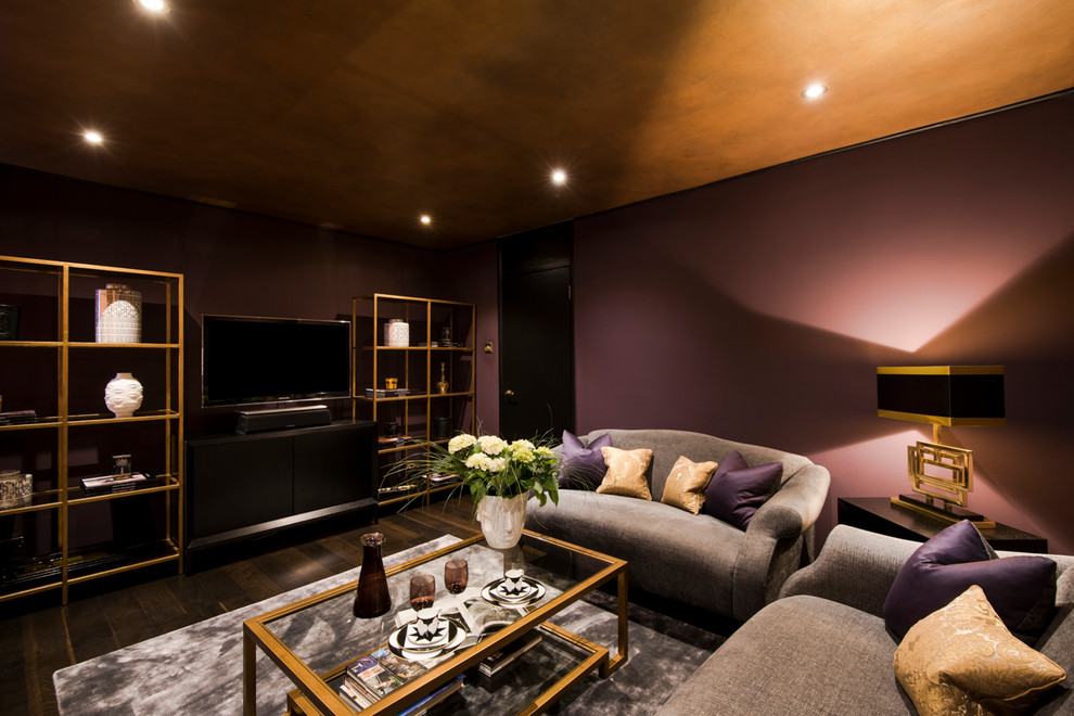 Photo of a mid-sized eclectic formal enclosed living room in London with purple walls, dark hardwood floors and a freestanding tv.