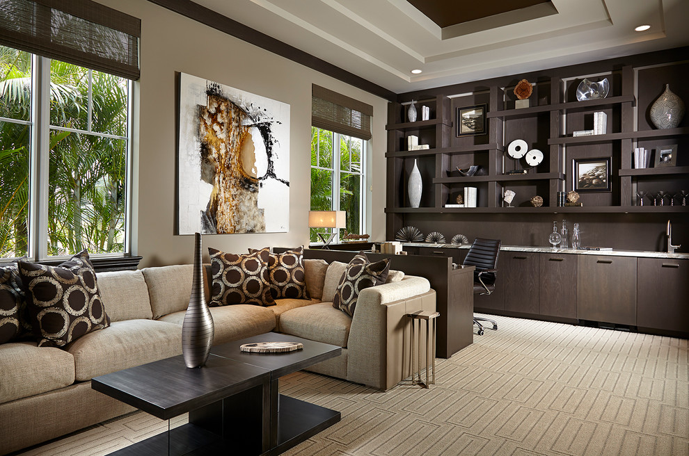 Example of a large transitional built-in desk carpeted and beige floor study room design in Miami with beige walls