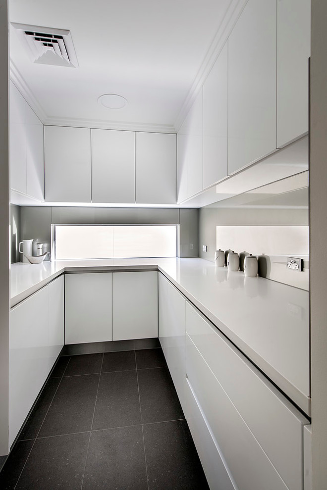 Photo of a contemporary u-shaped separate kitchen in Perth with flat-panel cabinets and white cabinets.