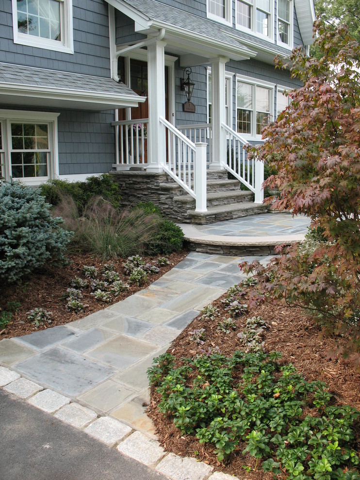 Design ideas for a mid-sized traditional partial sun front yard stone garden path.