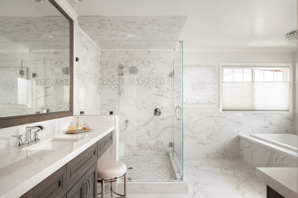 Inspiration for a traditional master bathroom in San Francisco with recessed-panel cabinets, dark wood cabinets, a drop-in tub, a corner shower, white tile, marble, white walls, marble floors, an undermount sink, white floor, a hinged shower door and white benchtops.