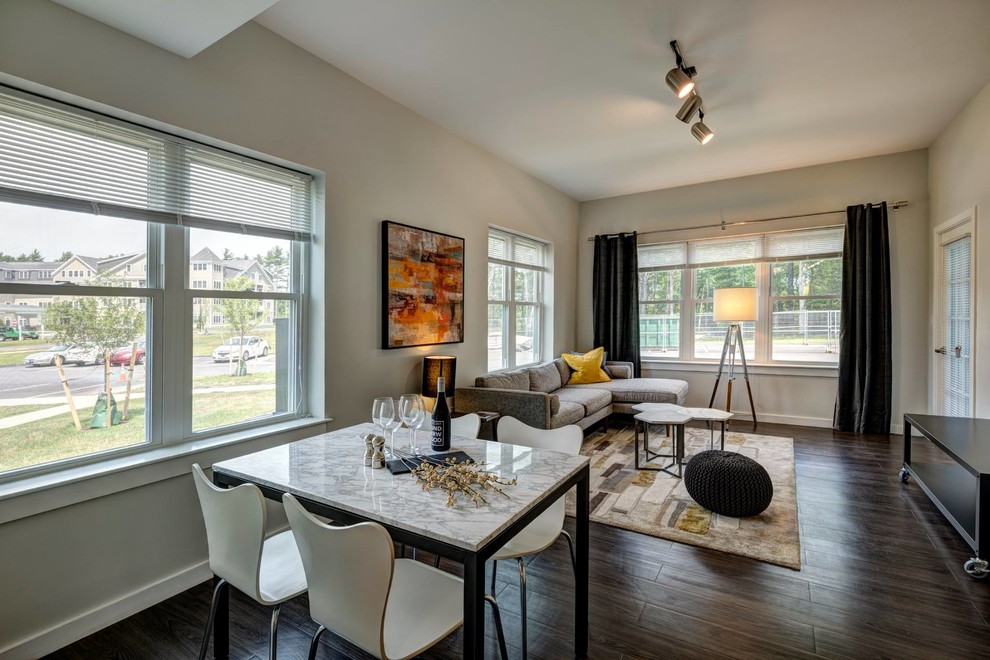 This is an example of a small modern open plan dining in Providence with beige walls, vinyl floors and brown floor.