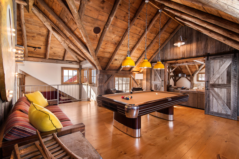 Country loft-style family room in New York with white walls and medium hardwood floors.