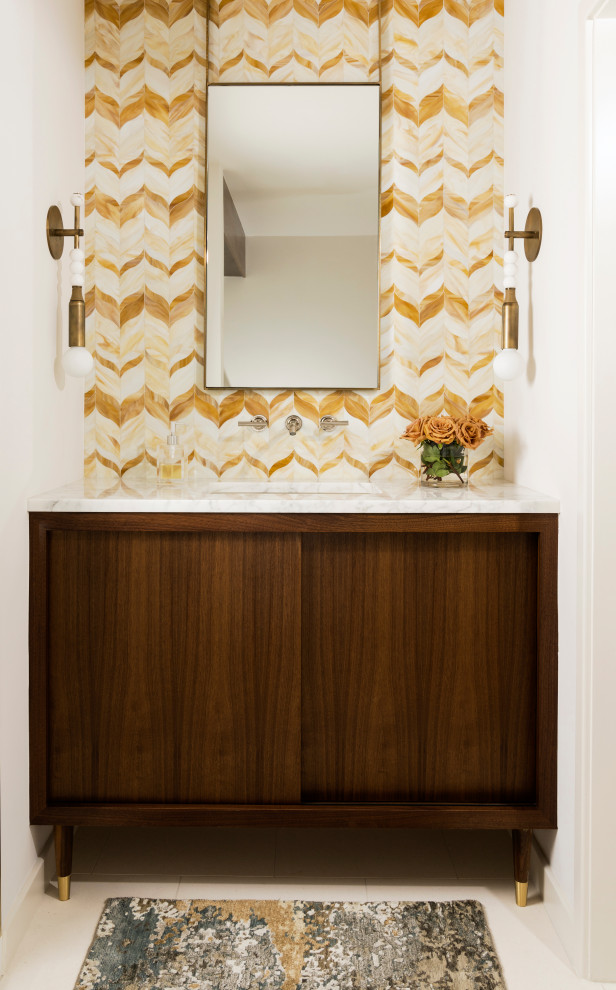 Inspiration for a mid-sized midcentury powder room in Houston with white walls, flat-panel cabinets, dark wood cabinets, multi-coloured tile, an undermount sink, beige floor, white benchtops and a freestanding vanity.
