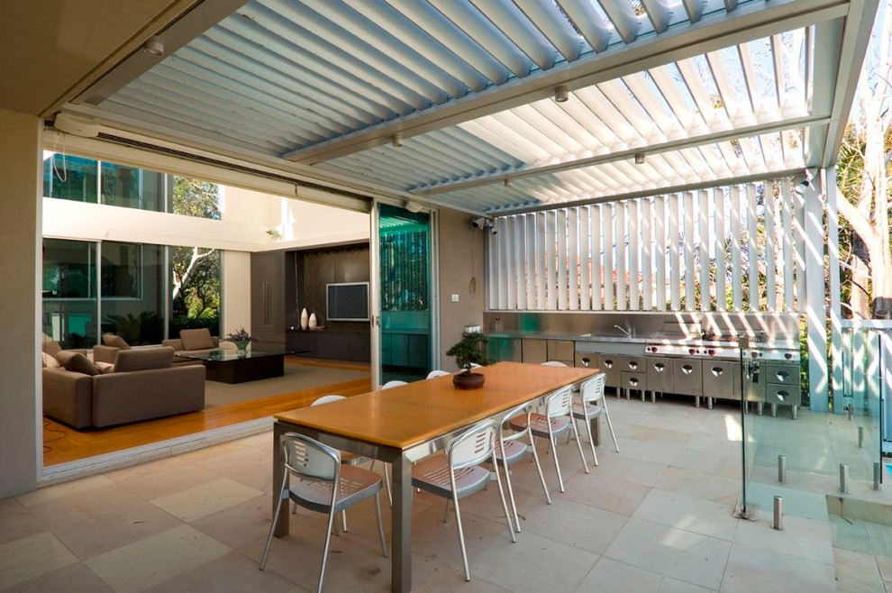 Inspiration for a contemporary courtyard patio in Sydney with tile and a pergola.