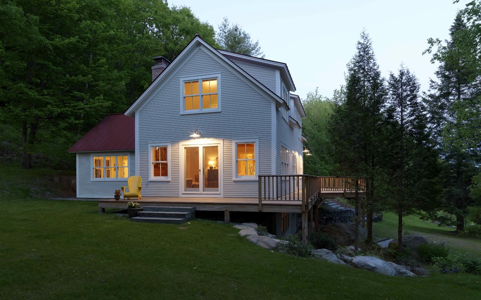 Design ideas for a country two-storey exterior in Burlington with wood siding.