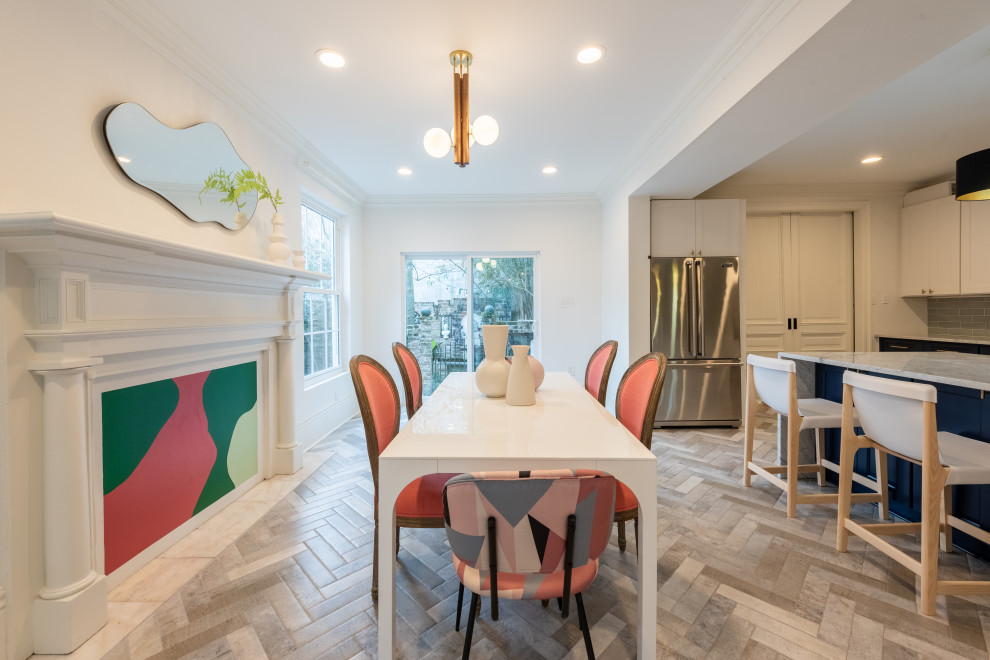 Photo of a mid-sized eclectic kitchen/dining combo in New Orleans with white walls, marble floors, no fireplace and grey floor.