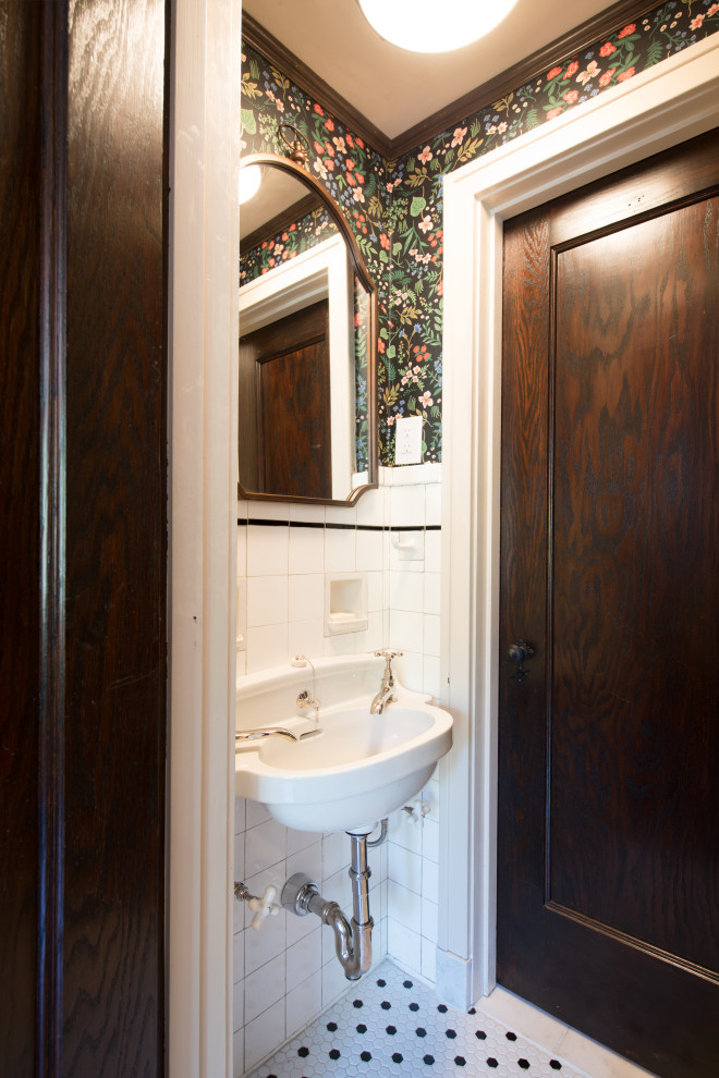 Example of a small classic white tile and porcelain tile porcelain tile, multicolored floor, single-sink and wallpaper bathroom design in Kansas City with recessed-panel cabinets, white cabinets, black walls and a wall-mount sink