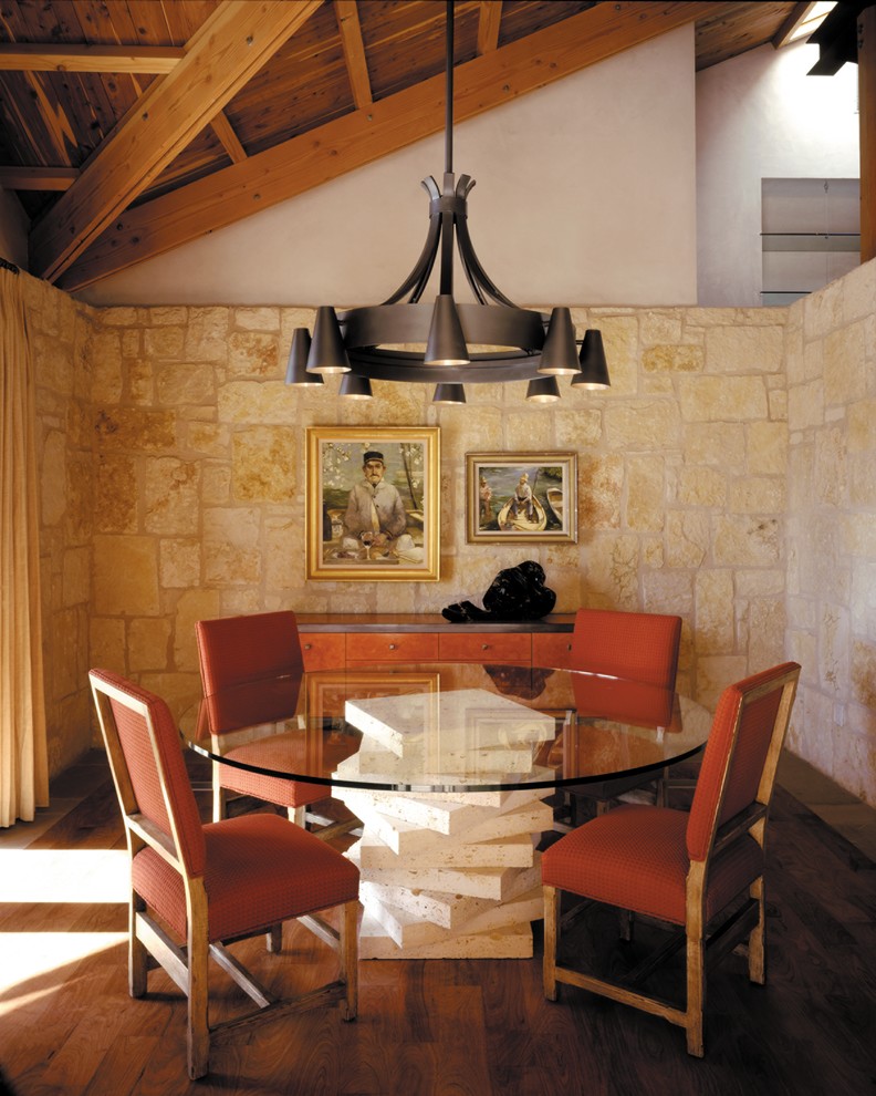 Mediterranean dining room in Austin with white walls and medium hardwood floors.