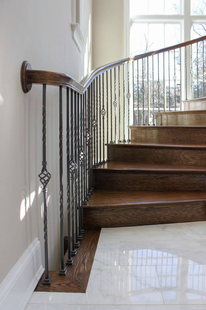 Design ideas for an expansive traditional wood spiral staircase in DC Metro with wood risers and mixed railing.