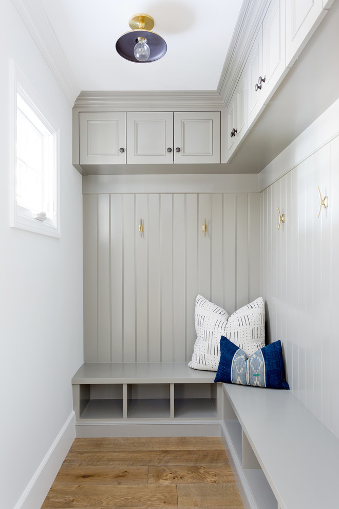 Inspiration for a small transitional light wood floor mudroom remodel in Orange County