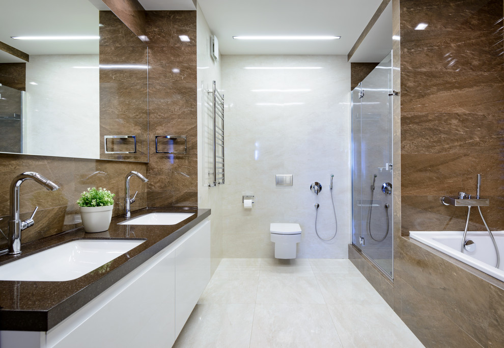 Photo of a contemporary master bathroom in Novosibirsk with flat-panel cabinets, white cabinets, a drop-in tub, an alcove shower, a wall-mount toilet, brown tile, white walls, an undermount sink, white floor, a hinged shower door and brown benchtops.