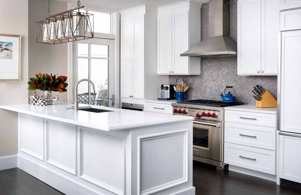 Inspiration for a mid-sized transitional galley kitchen in Denver with an undermount sink, shaker cabinets, white cabinets, grey splashback, stainless steel appliances, dark hardwood floors, with island, matchstick tile splashback, brown floor and white benchtop.