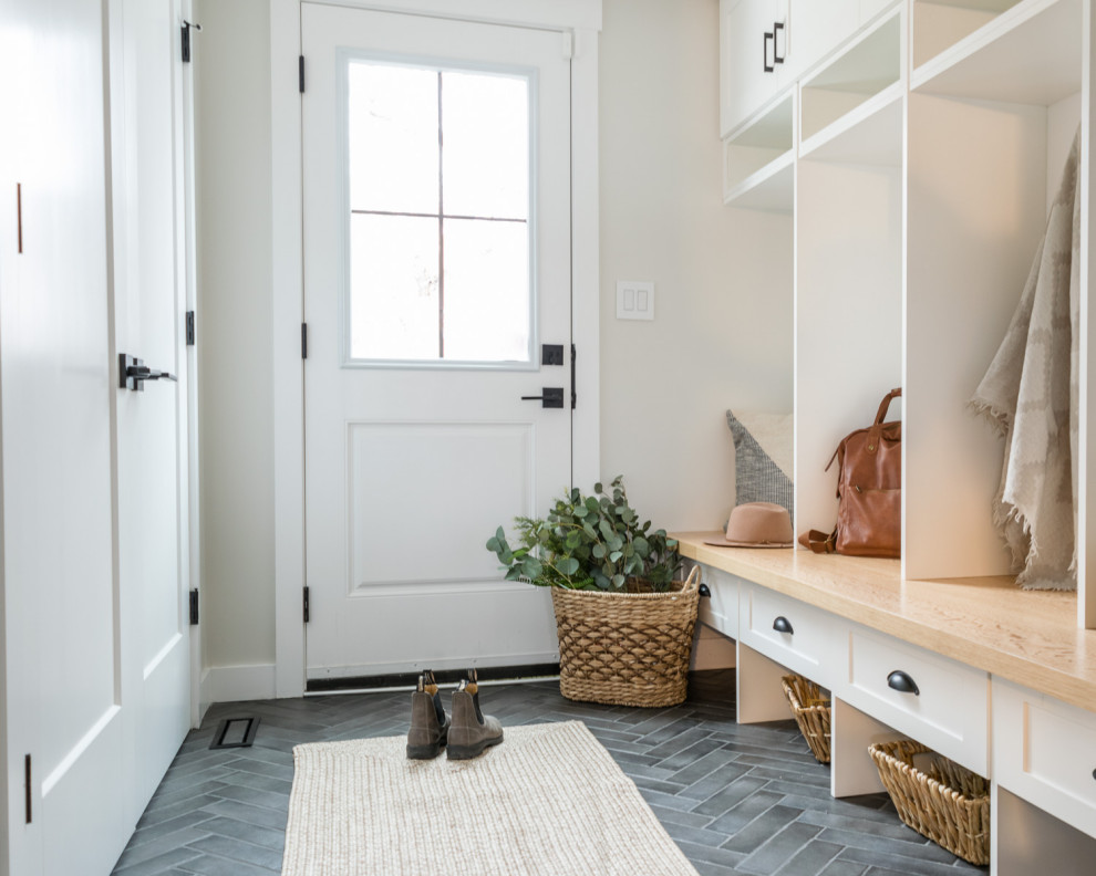 Photo of a mid-sized transitional mudroom in Other with white walls, porcelain floors, a single front door, a white front door and grey floor.