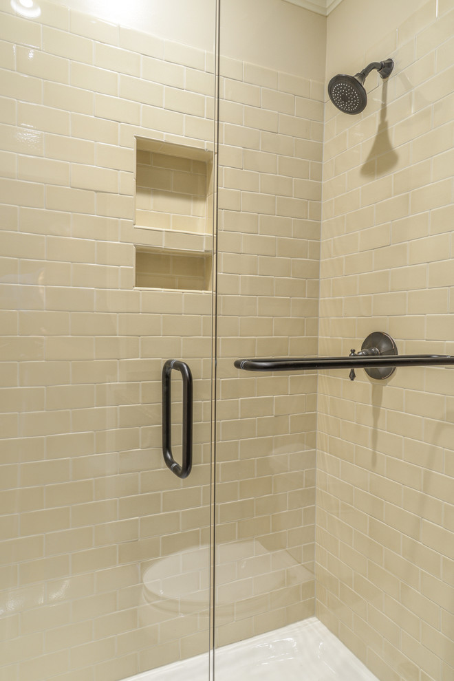 Inspiration for a mid-sized rustic 3/4 beige tile and subway tile concrete floor and brown floor alcove shower remodel with recessed-panel cabinets, dark wood cabinets, a two-piece toilet, beige walls, an undermount sink, granite countertops and brown countertops