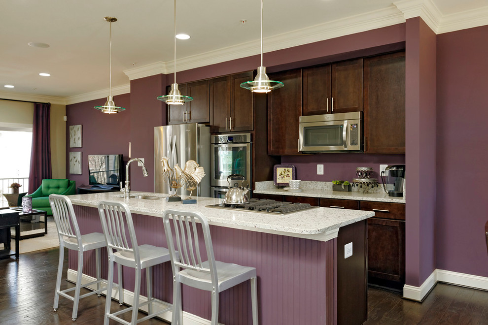 Large transitional single-wall dark wood floor eat-in kitchen photo in Baltimore with an undermount sink, recessed-panel cabinets, dark wood cabinets, granite countertops, stainless steel appliances and an island