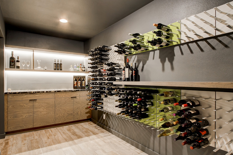 Photo of a mid-sized contemporary wine cellar in Seattle with storage racks, medium hardwood floors and beige floor.