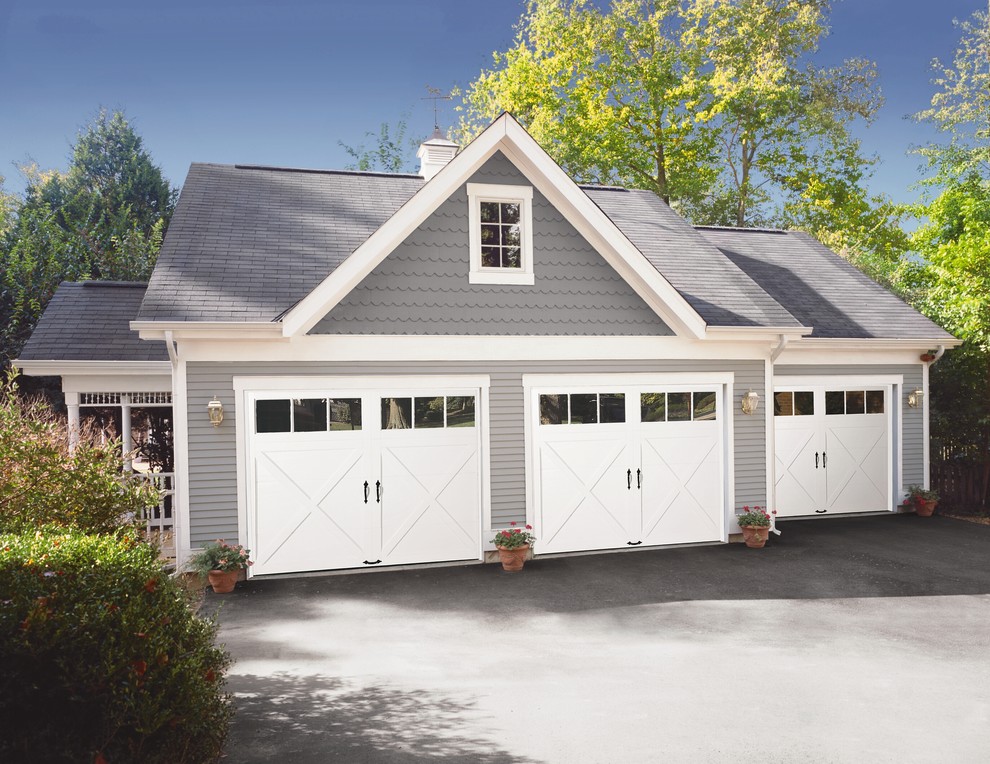 Photo of a mid-sized arts and crafts detached three-car garage in Other.
