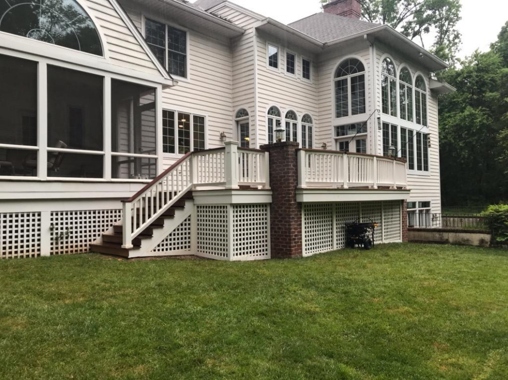 Example of a large transitional backyard deck design in Philadelphia with no cover