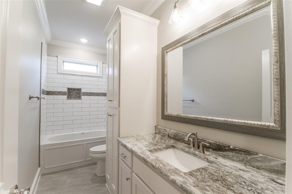 Design ideas for a small modern kids bathroom in Little Rock with shaker cabinets, white cabinets, an alcove shower, gray tile, ceramic tile, white walls, porcelain floors, an undermount sink, quartzite benchtops, grey floor, a shower curtain and multi-coloured benchtops.