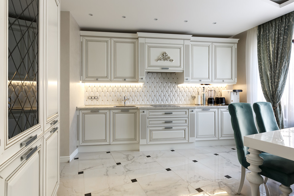 Design ideas for a small transitional l-shaped separate kitchen in Saint Petersburg with an undermount sink, raised-panel cabinets, white cabinets, quartz benchtops, white splashback, ceramic splashback, stainless steel appliances, porcelain floors, no island, white floor and white benchtop.