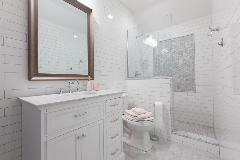 This is an example of a mid-sized traditional kids bathroom in Chicago with flat-panel cabinets, white cabinets, a corner shower, white tile, ceramic tile, grey walls, marble floors, an undermount sink, marble benchtops, grey floor, a hinged shower door, grey benchtops, a niche, a single vanity and a freestanding vanity.
